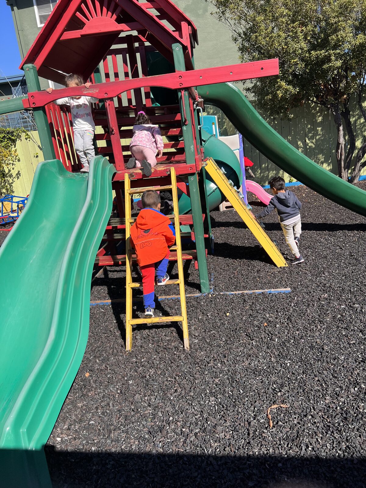 Colorful outdoor play structure in the Bubbly Tots play yard